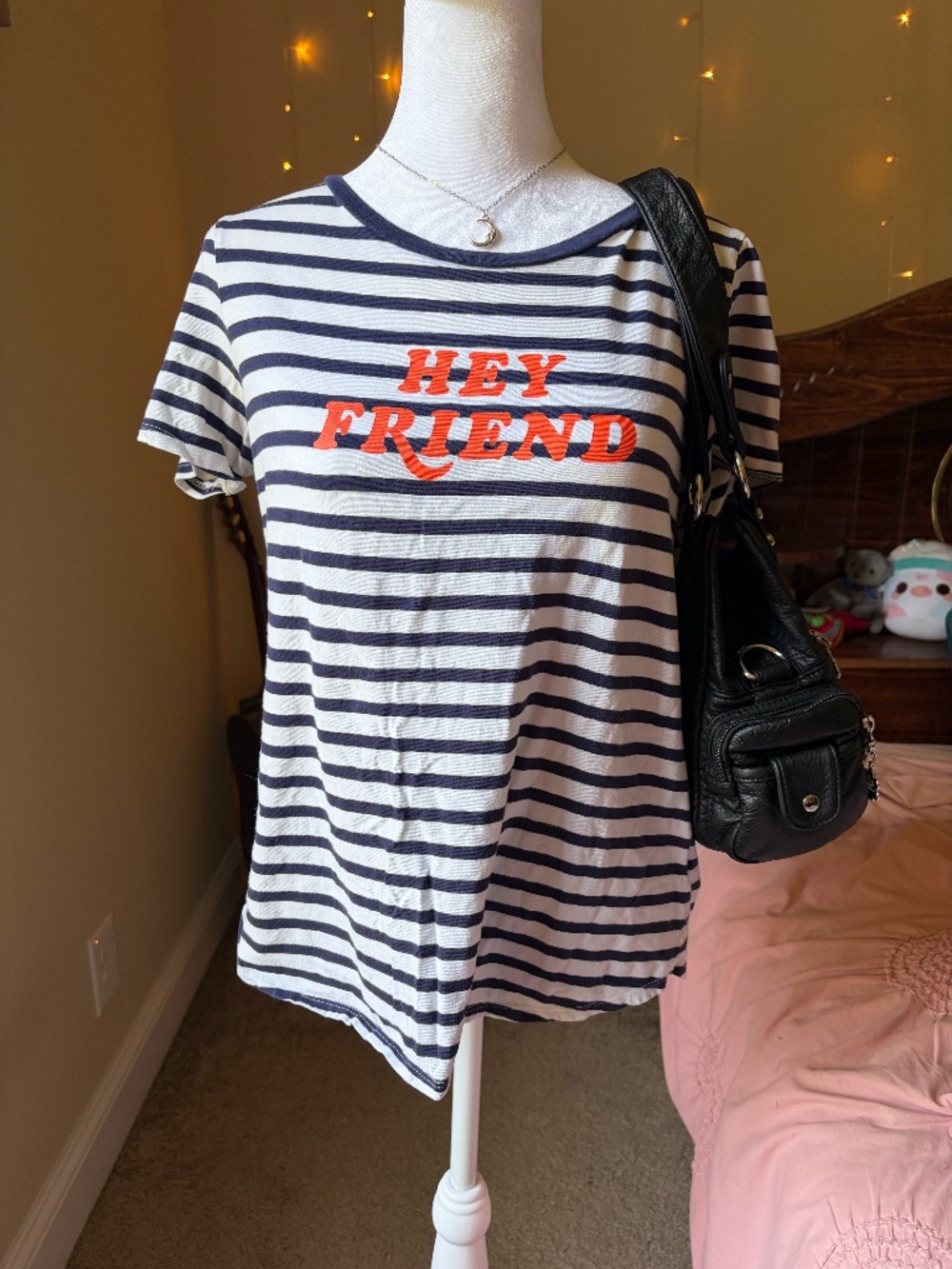 navy blue and white striped t-shirt features a "HEY FRIEND" graphic tee